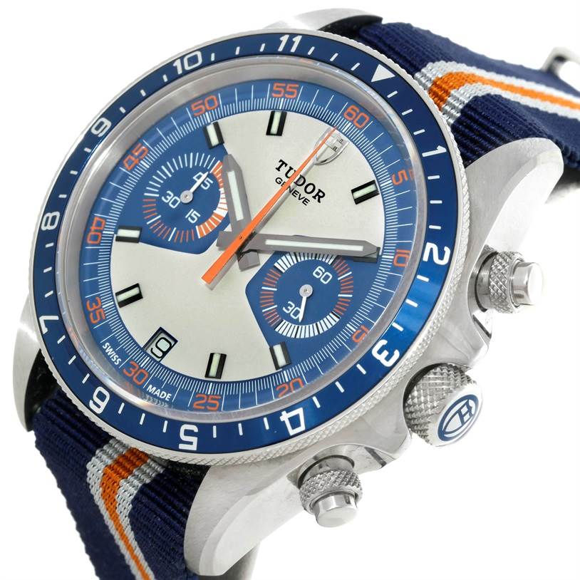 The image shows a side and front view of a Tudor Heritage Chrono 79220R Men's Stainless Steel Blue Dial 79220R Men's Stainless Steel Blue Dial watch, highlighting its dial, bezel, and crown.