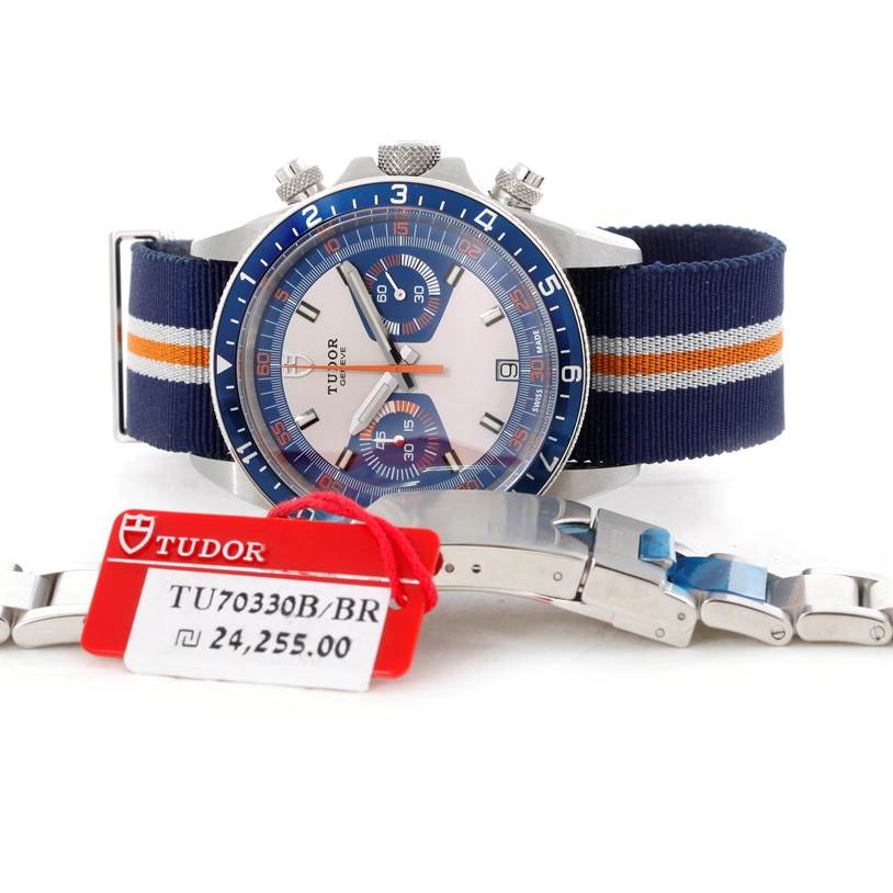 The image shows a Tudor Heritage Chrono 79220R Men's Stainless Steel Blue Dial 79220R Men's Stainless Steel Blue Dial watch at an angled front view, along with a metal bracelet and a price tag.