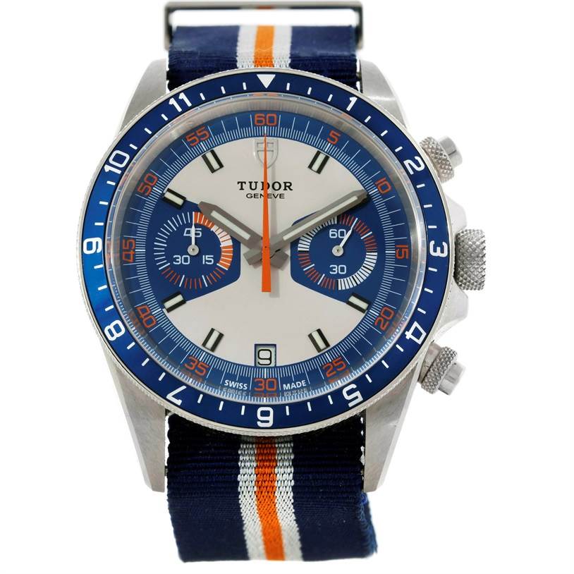 The image shows a front view of the Tudor Heritage Chrono 79220R Men's Stainless Steel Blue Dial 79220R Men's Stainless Steel Blue Dial watch, featuring its dial, bezel, and striped NATO strap.