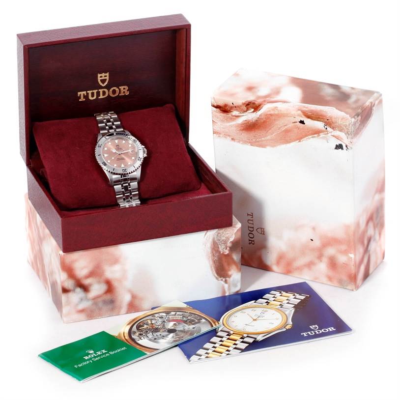 The Tudor Submariner 75190 Men's Stainless Steel Pink Dial 75190 Men's Stainless Steel Pink Dial watch is shown inside an open display box alongside its outer packaging and instruction booklets.