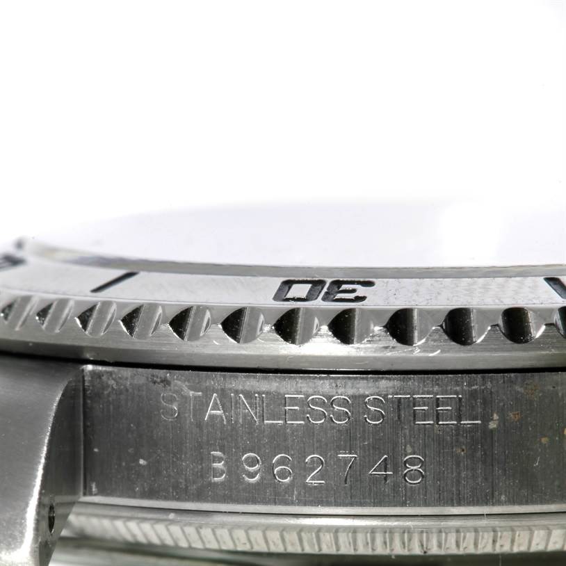 This image shows a close-up side view of a stainless steel Tudor Submariner 75190 Men's Stainless Steel Pink Dial 75190 Men's Stainless Steel Pink Dial watch, focusing on its bezel and serial number.