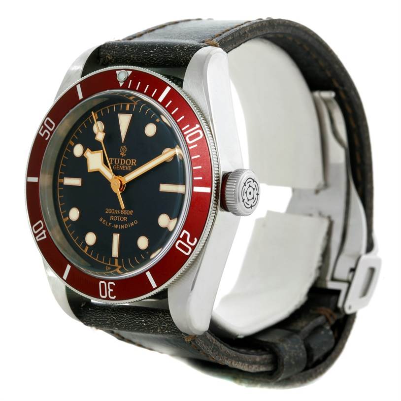 The Tudor Heritage Black Bay 79220R Men's Stainless Steel Black Dial 79220R Men's Stainless Steel Black Dial watch is shown at a three-quarter angle, highlighting the face, bezel, crown, and strap.