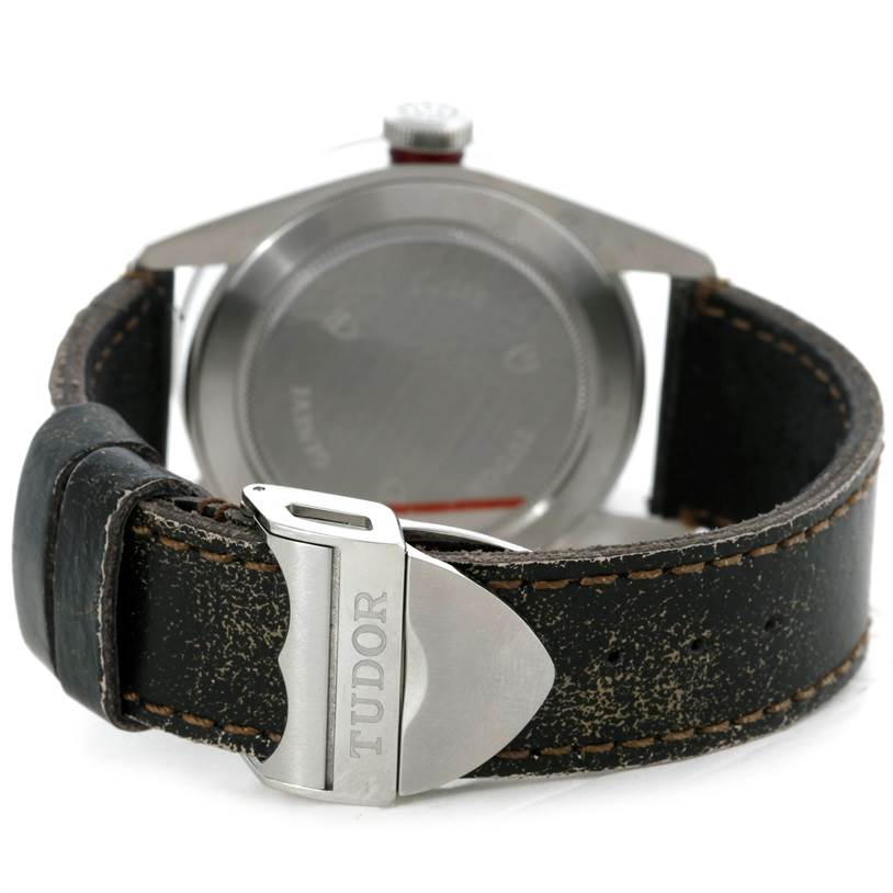 This image shows the back view of a Tudor Heritage Black Bay 79220R Men's Stainless Steel Black Dial 79220R Men's Stainless Steel Black Dial watch, highlighting the case back and the leather strap with a Tudor-branded clasp.