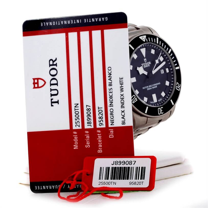 The Tudor Pelagos 25500TN Men
s Titanium Black Dial 25500TN Men
s Titanium Black Dial watch is shown at an angled view alongside its warranty card and tag.
