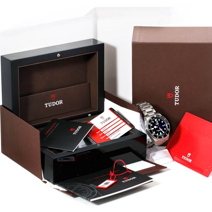 The image shows a Tudor Pelagos 25500TN Men
s Titanium Black Dial 25500TN Men
s Titanium Black Dial watch, its box, manuals, warranty cards, and packaging materials from a front angle.
