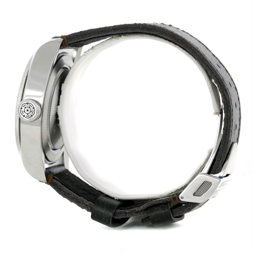 The image shows a side view of the Tudor Heritage Black Bay 79220R Men's Stainless Steel Black Dial 79220R Men's Stainless Steel Black Dial watch, highlighting its case, crown, and leather strap.