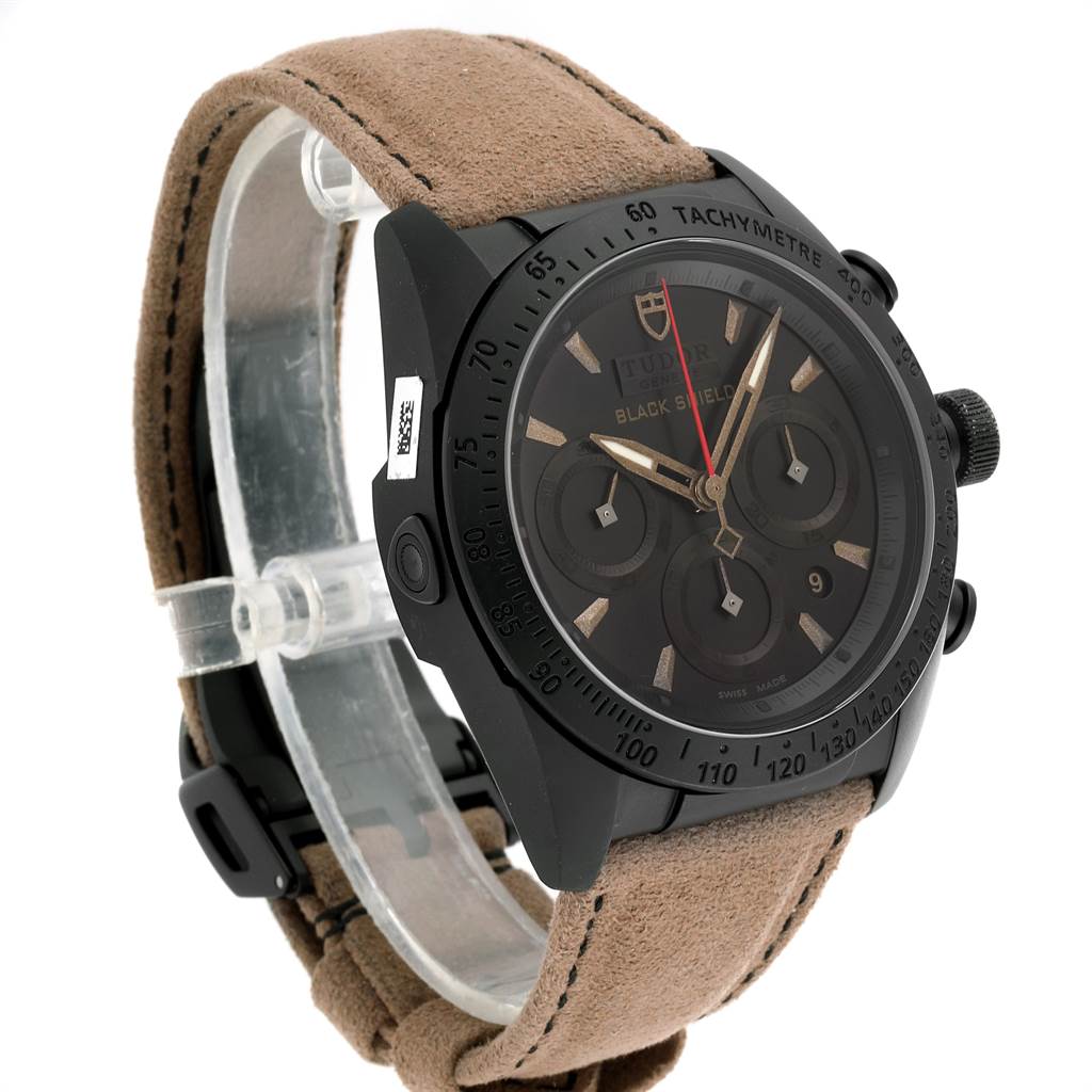 This image shows a Tudor Fastrider 42000CN Men's Stainless Steel Black Dial 42000CN Men's Stainless Steel Black Dial watch at a side angle, highlighting the dial, bezel, and suede strap.