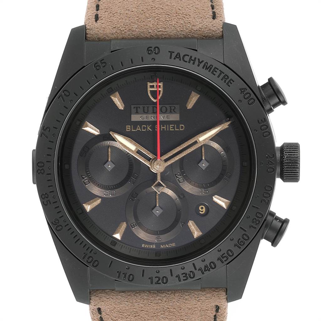 The image shows a front view of the Tudor Fastrider 42000CN Men's Stainless Steel Black Dial 42000CN Men's Stainless Steel Black Dial Black Shield with a black case, tachymeter bezel, and beige leather strap.