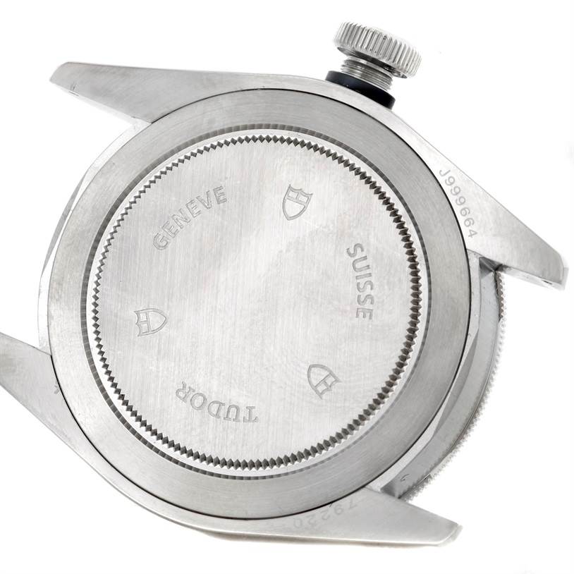 The image shows the back case and crown of a Tudor Heritage Black Bay 79220 Men's Stainless Steel Black Dial 79220 Men's Stainless Steel Black Dial watch from a top-down angle.