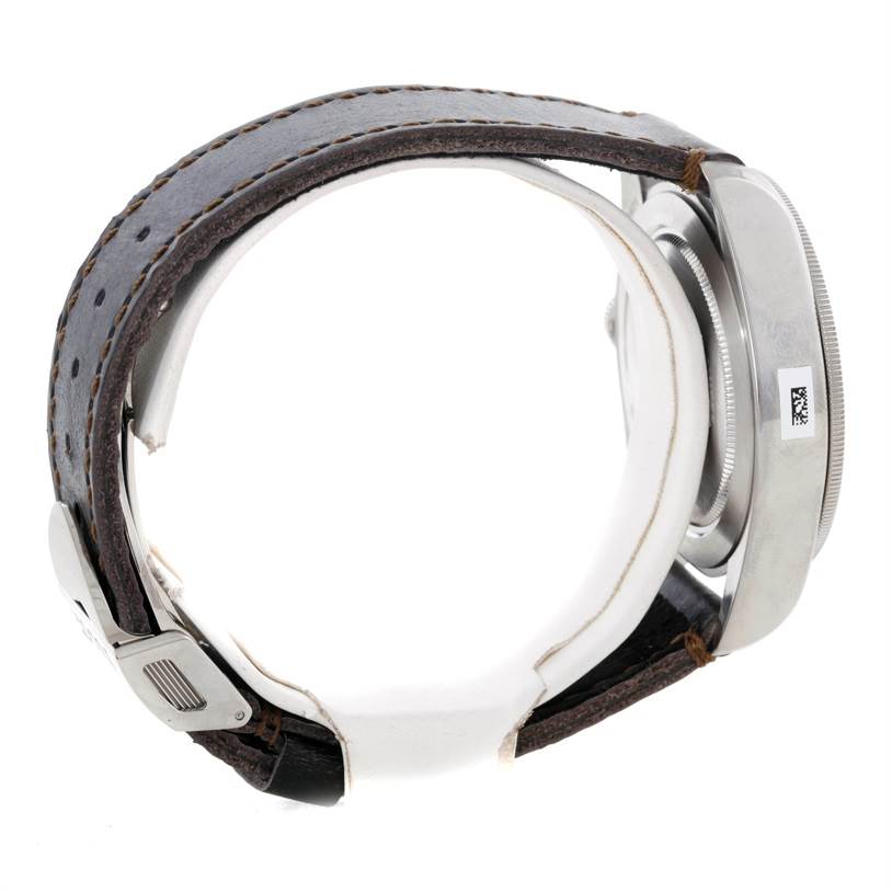 The image shows a side view of the Tudor Heritage Black Bay 79220R Men
s Stainless Steel Black Dial 79220R Men
s Stainless Steel Black Dial watch, highlighting the case, bezel, and leather strap.