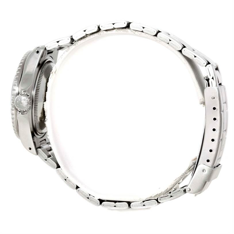 The image shows a side profile of a Tudor Submariner 73090 Men's Stainless Steel Black Dial 73090 Men's Stainless Steel Black Dial watch, highlighting its case, crown, and metal bracelet.