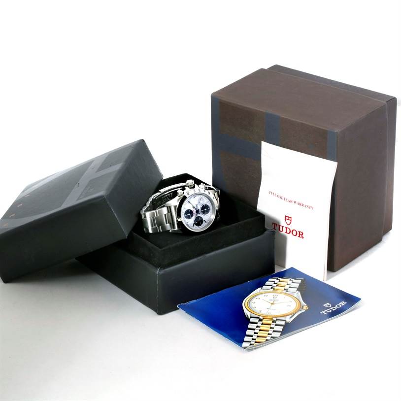 The image shows a Tudor Tiger 79280 Men's Stainless Steel White Dial 79280 Men's Stainless Steel White Dial model watch at a 3/4 angle, inside an open box with warranty papers and a booklet.