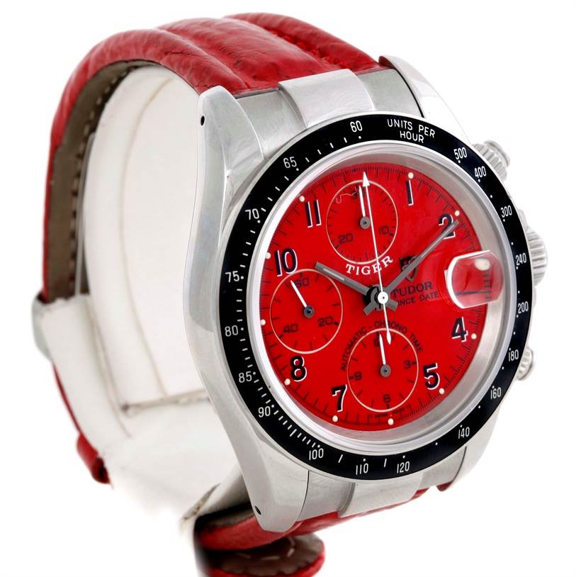 The image shows a Tudor Prince chronograph watch in a side profile, highlighting the red dial, bezel, and red leather strap.