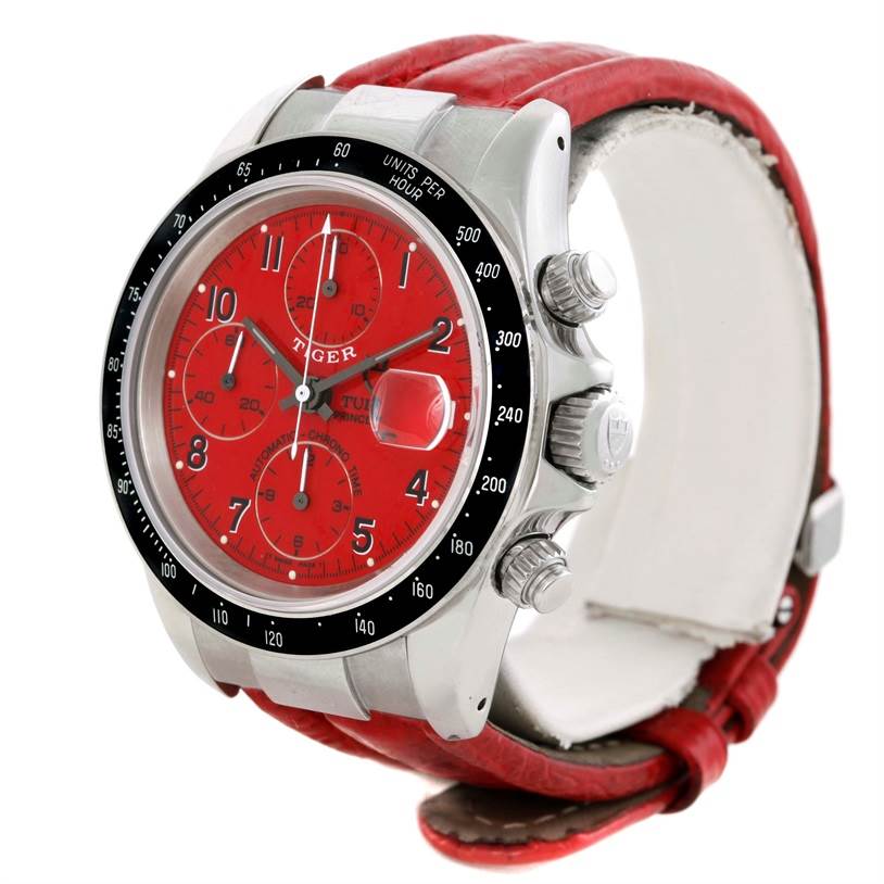 The Tudor Prince watch is shown at a front-left angle, highlighting its red dial, bezel, crown, and chronograph pushers.