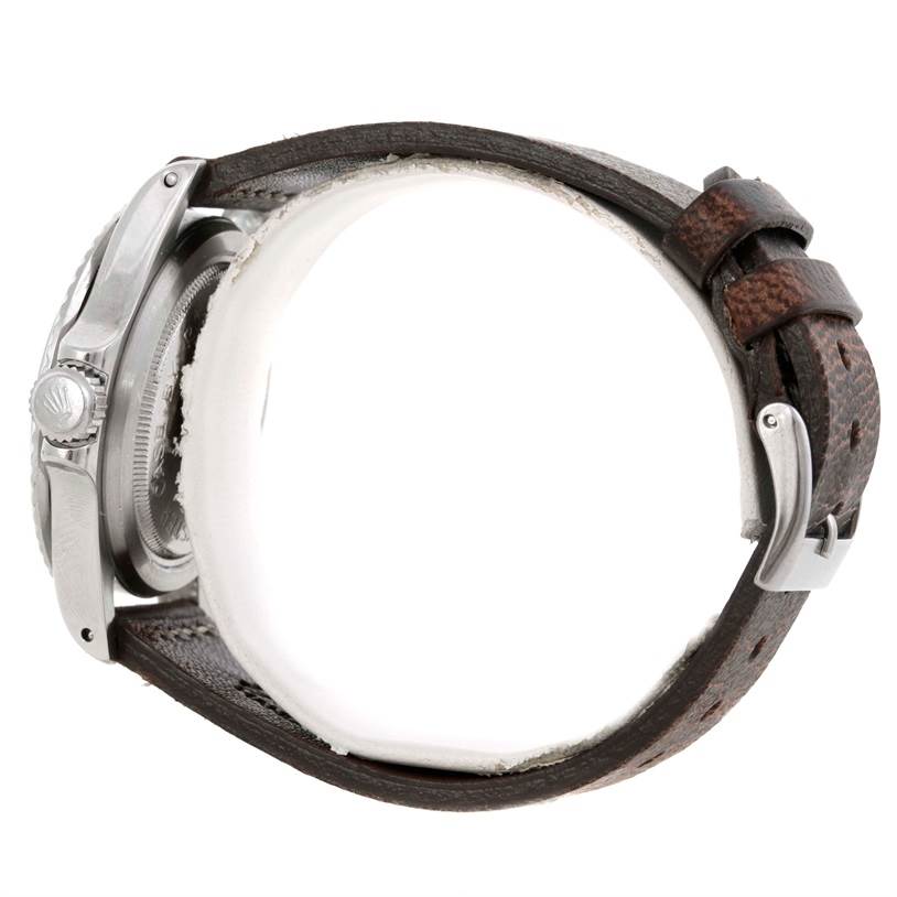 This side view of the Tudor Submariner 7016 Men's Stainless Steel Black Dial 7016 Men's Stainless Steel Black Dial shows the crown, part of the case, and a brown leather strap with a buckle.