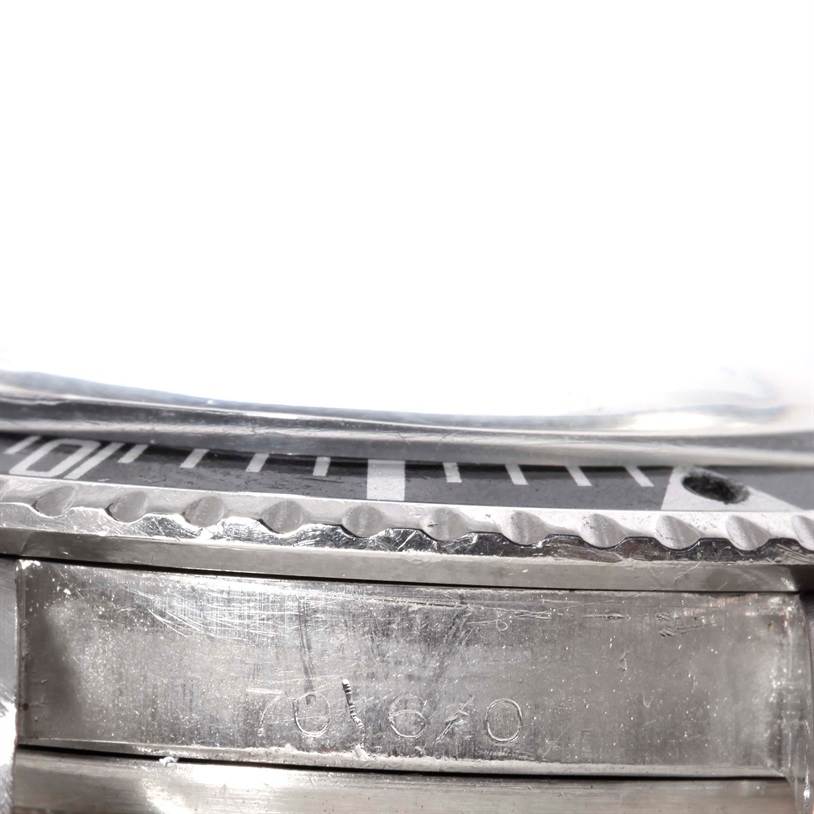 This close-up image shows the side of the case and bezel edge of a Tudor Submariner 7016 Men's Stainless Steel Black Dial 7016 Men's Stainless Steel Black Dial watch, including part of the engraved model number.