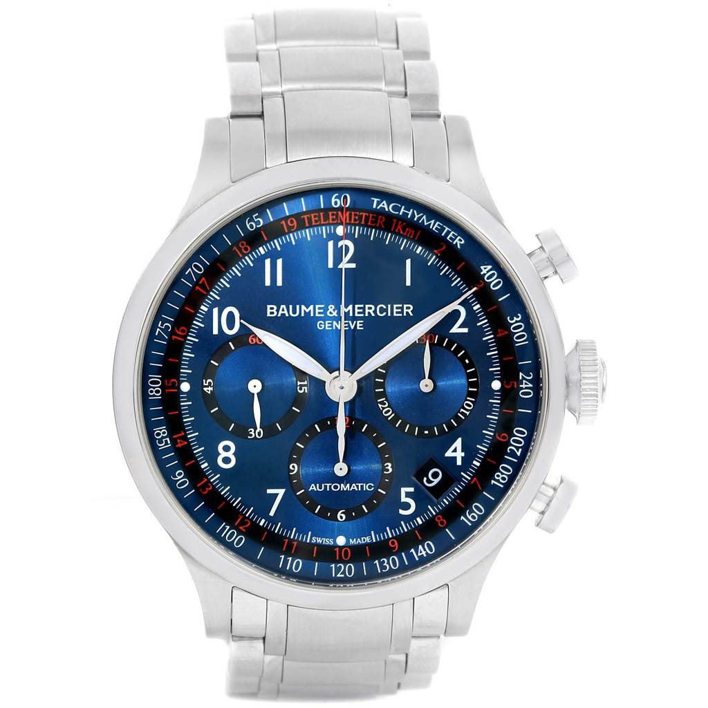 The image shows a Baume & Mercier Capeland 10066 Men's Stainless Steel Blue Dial 10066 Men's Stainless Steel Blue Dial watch from a front angle, displaying its blue dial, chronograph subdials, and silver bracelet.