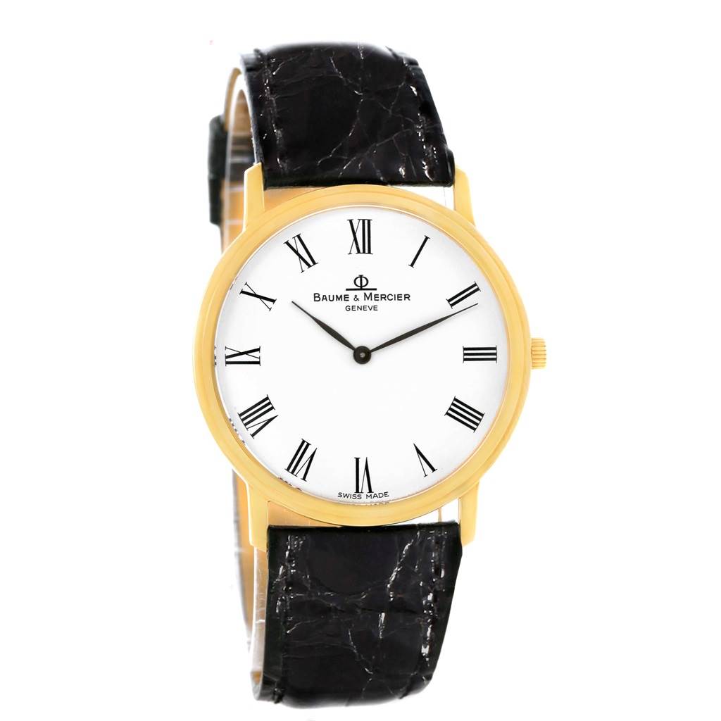 The Baume & Mercier Classima MV045088 Men's Yellow Gold White Dial MV045088 Men's Yellow Gold White Dial watch is shown from a front angle, displaying its gold case, white dial with Roman numerals, and black leather strap.