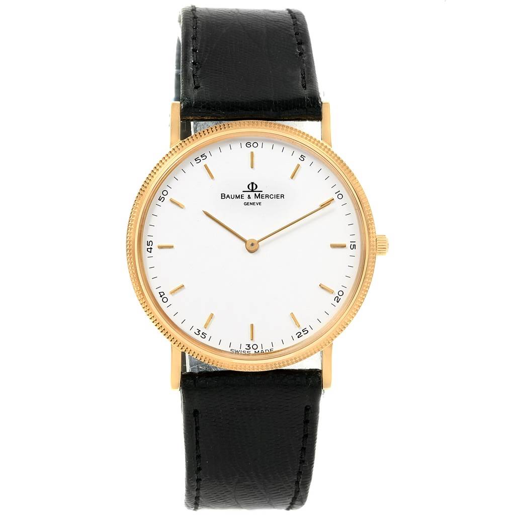 The image shows a front view of a Baume & Mercier Classima 15603 Men's Yellow Gold White Dial 15603 Men's Yellow Gold White Dial watch with a white dial, gold case, and black leather strap.