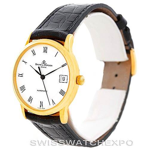 The image shows a Baume & Mercier Classima MV045075 Men's Yellow Gold White Dial MV045075 Men's Yellow Gold White Dial watch at a slight angle, featuring a gold case, white dial, black leather strap, and Roman numeral markers.