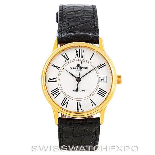 This image shows a front view of the Baume 
Mercier Classima MV045075 Men
s Yellow Gold White Dial MV045075 Men
s Yellow Gold White Dial watch, featuring a gold case, white dial, Roman numeral indices, and a black leather strap.