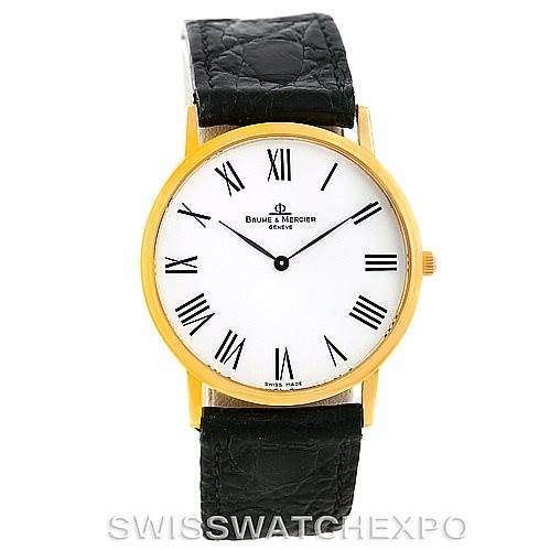 The image shows a front view of the Baume & Mercier Classima MV045088 Men's Yellow Gold White Dial MV045088 Men's Yellow Gold White Dial watch, displaying its face, case, crown, and black leather strap.