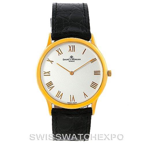 The Classima model by Baume & Mercier is shown from a front angle, displaying its face, gold case, and black leather strap.