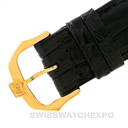 The image shows the gold-tone pin buckle of a Baume & Mercier Classima MV045088 Men's Yellow Gold White Dial MV045088 Men's Yellow Gold White Dial watch strap viewed from an angle.