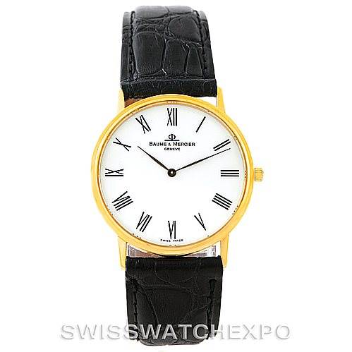 The image shows a front view of the Baume & Mercier Classima MV045088 Men's Yellow Gold White Dial MV045088 Men's Yellow Gold White Dial watch with a gold case, white dial, and black leather strap.