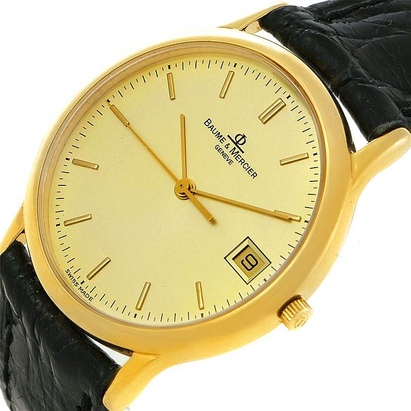 The image shows a close-up angled view of the Baume & Mercier Classima 6149 Men's Yellow Gold Champagne Dial 6149 Men's Yellow Gold Champagne Dial watch, highlighting the face, crown, and part of the strap.