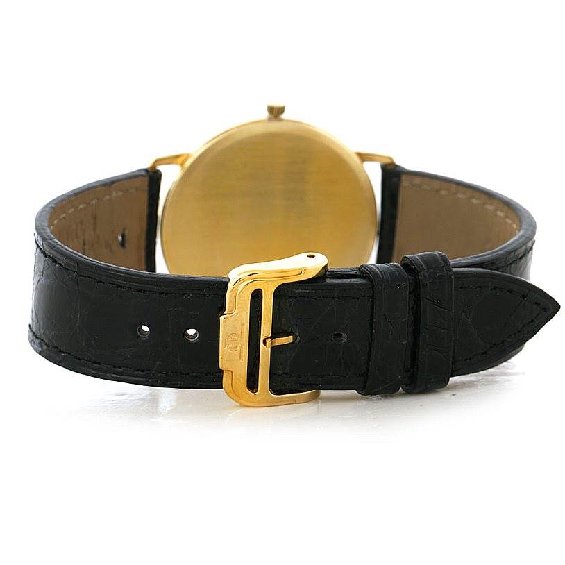 This image shows the back of the Baume & Mercier Classima 95712 Men's Yellow Gold White Dial 95712 Men's Yellow Gold White Dial watch, highlighting its black leather strap and gold buckle.