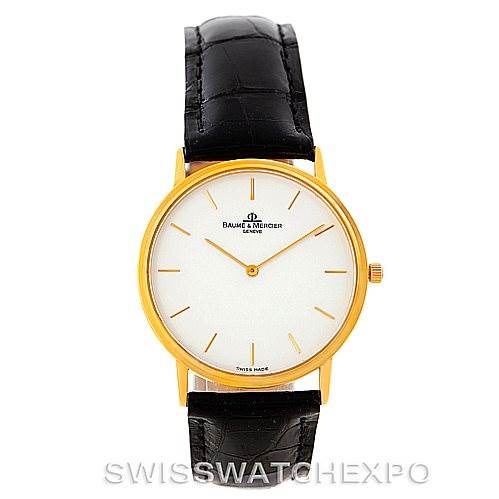 The image shows a front view of a Baume & Mercier Classima MV045088 Men's Yellow Gold White Dial MV045088 Men's Yellow Gold White Dial watch with a gold case and a black leather strap.