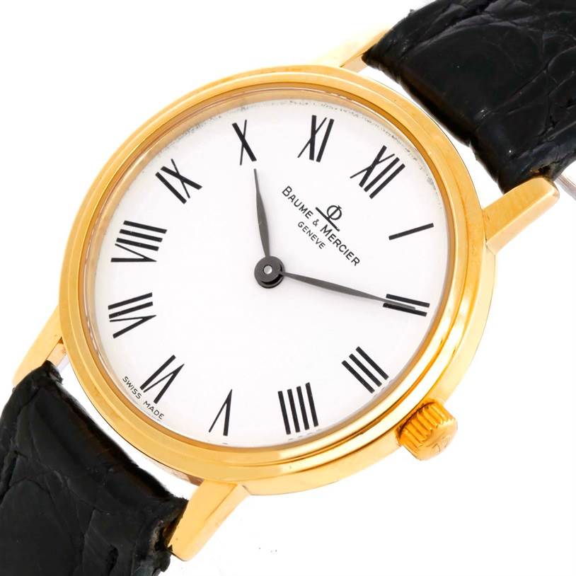 The image shows a front view of the Baume & Mercier MV045089 Women's Yellow Gold White Dial MV045089 Women's Yellow Gold White Dial Classima Ladies 18K Yellow Gold Quartz Watch MV045089, highlighting its face and strap.