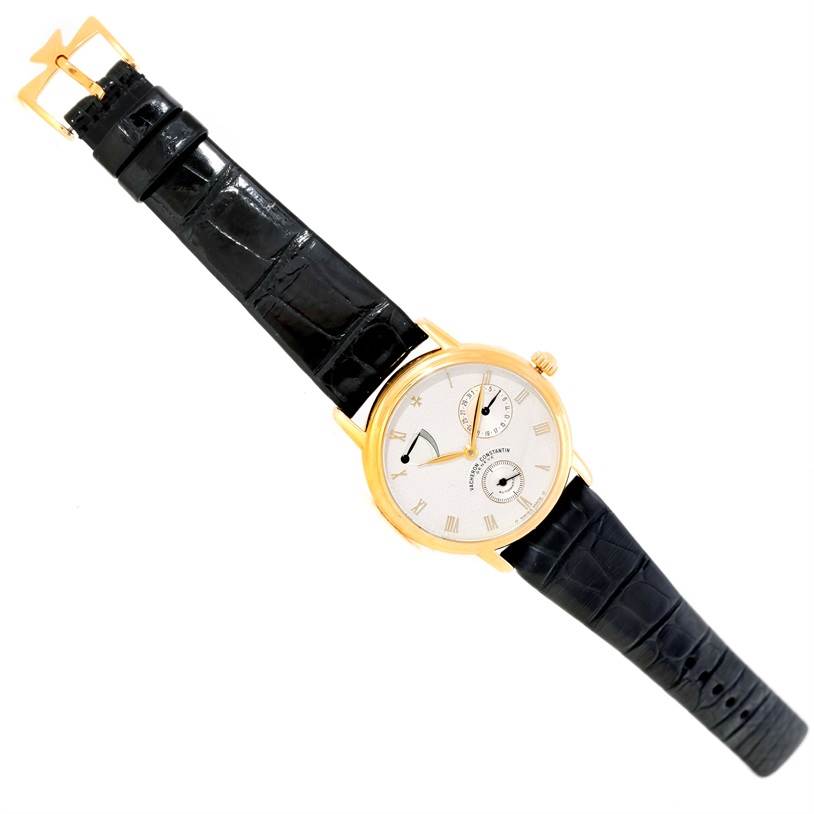 The image shows a top view of a Vacheron Constantin Patrimony 47200/1 Men's Yellow Gold Silver Dial 47200/1 Men's Yellow Gold Silver Dial watch with a gold case and a black leather strap.