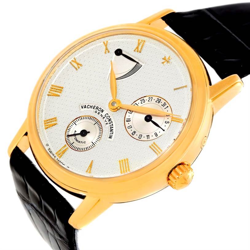 The Vacheron Constantin Patrimony 47200/1 Men's Yellow Gold Silver Dial 47200/1 Men's Yellow Gold Silver Dial watch is shown at an oblique angle, highlighting its face, gold case, crown, and black leather strap.