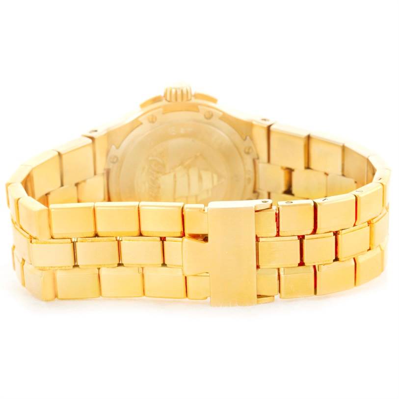 This Vacheron Constantin Overseas 42050/423J Men's Yellow Gold Silver Dial 42050/423J Men's Yellow Gold Silver Dial watch is shown from the back, highlighting its gold bracelet and clasp.