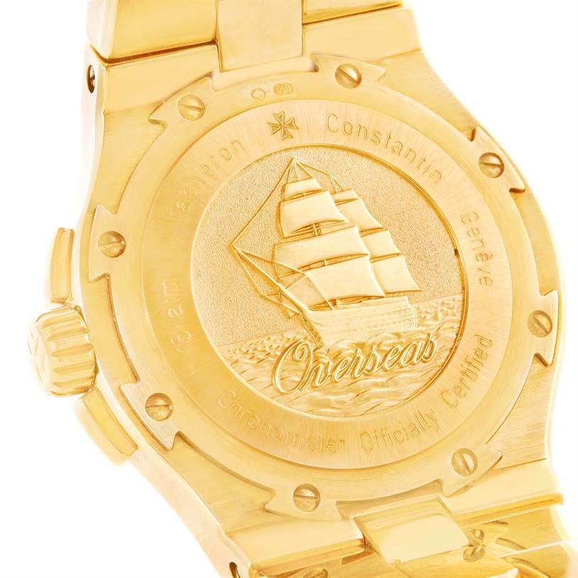 The image shows the engraved caseback of a Vacheron Constantin Overseas 42050/423J Men's Yellow Gold Silver Dial 42050/423J Men's Yellow Gold Silver Dial watch, highlighting the intricate ship design and "Overseas" lettering.