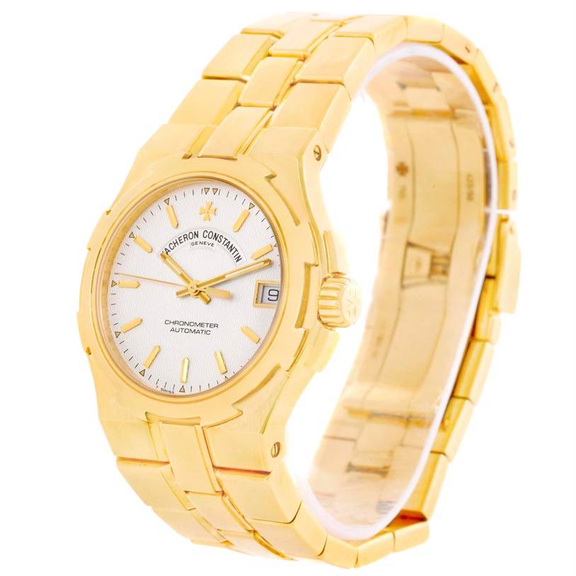 The Vacheron Constantin Overseas 42050/423J Men's Yellow Gold Silver Dial 42050/423J Men's Yellow Gold Silver Dial model watch is shown at an oblique angle, displaying its face and bracelet clearly.