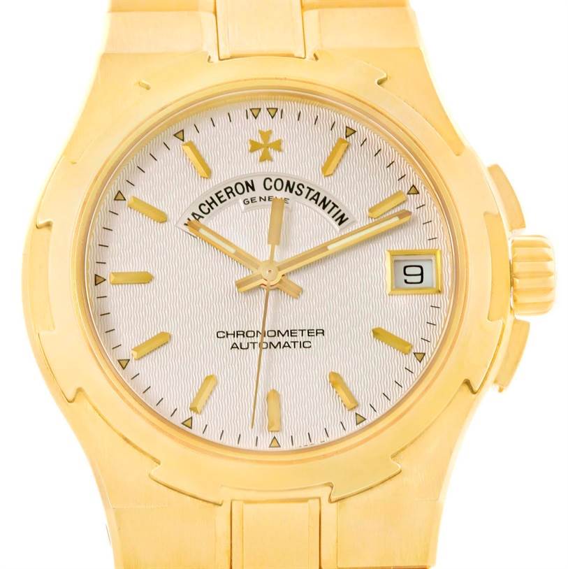 The image shows a close-up view of the Vacheron Constantin Overseas 42050/423J Men's Yellow Gold Silver Dial 42050/423J Men's Yellow Gold Silver Dial model, highlighting the dial, hands, date window, and part of the bracelet.