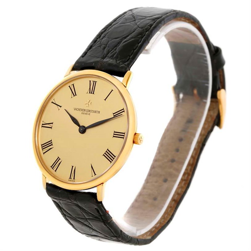 This image shows a side-angle view of a Vintage Vacheron Constantin watch, highlighting the face, Roman numerals, black leather strap, and gold casing.