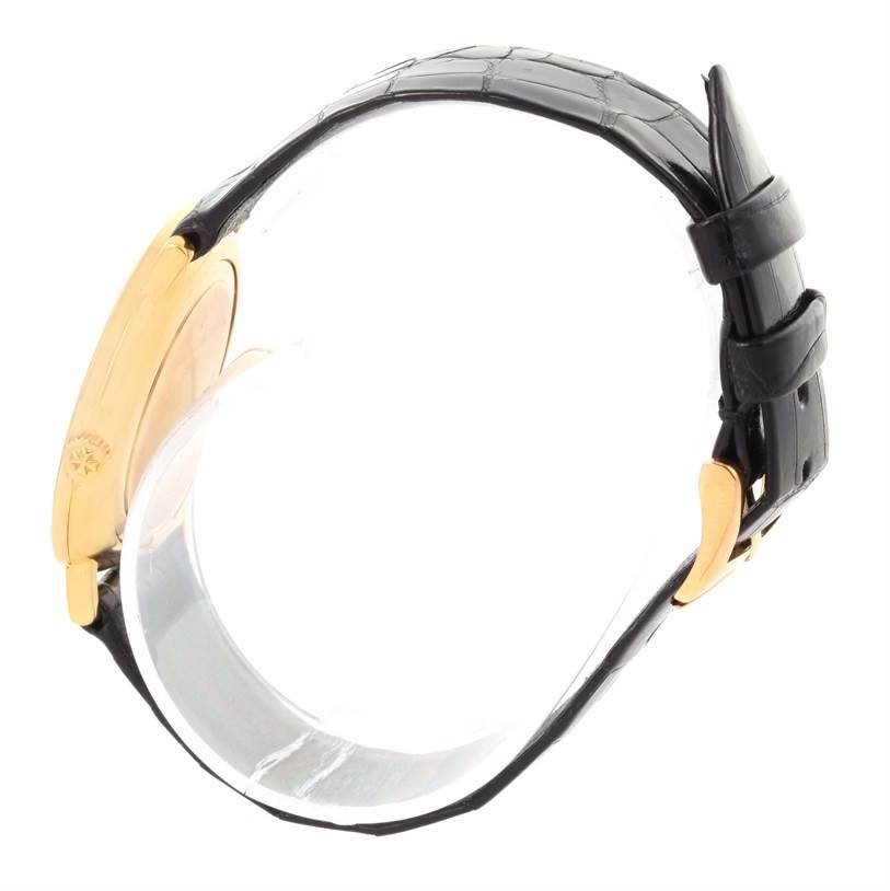 This side view of the Vintage Vacheron Constantin watch shows its black leather strap and gold case.