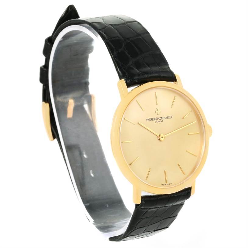 The image shows a front-side view of a Vintage Vacheron Constantin watch with a black leather strap and gold dial.