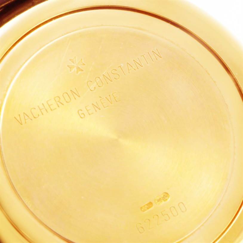 The image shows the back case of a Vintage Vacheron Constantin watch, with engraving and serial number visible.