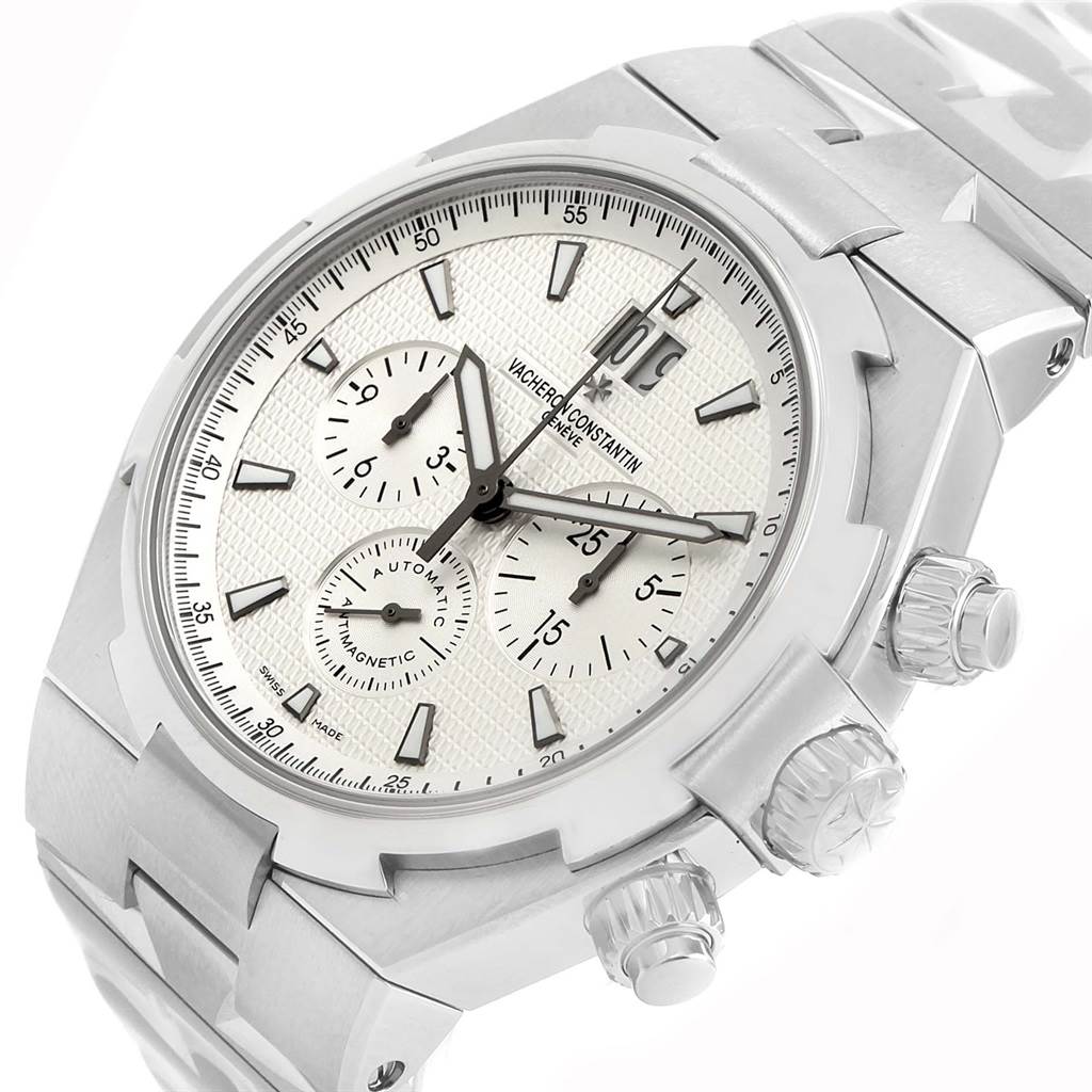 The Vacheron Constantin Overseas 49150 Men's Stainless Steel Silver Dial 49150 Men's Stainless Steel Silver Dial watch is shown at a 3/4 angle, highlighting the dial, crown, pushers, and part of the bracelet.