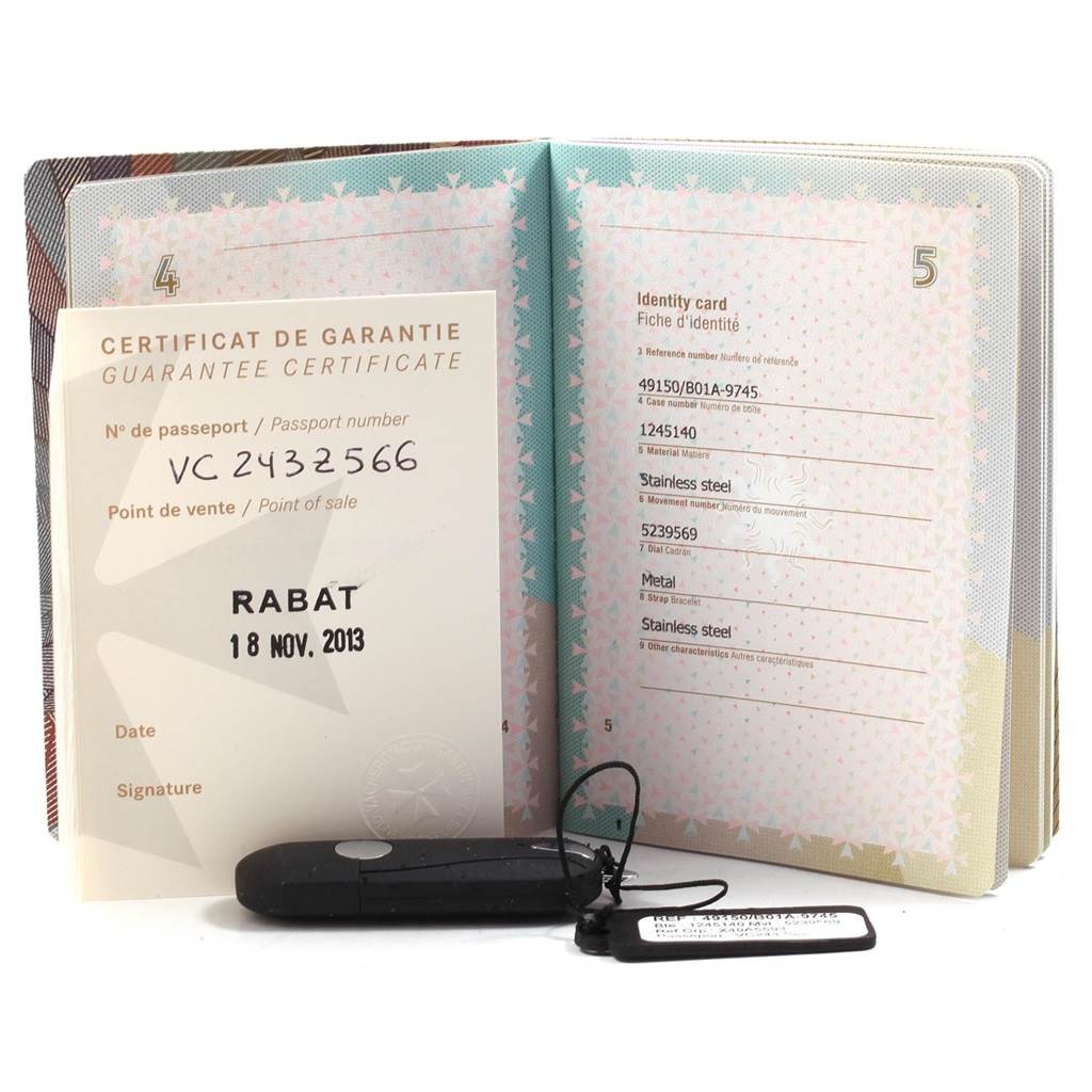 The image shows the guarantee certificate for the Vacheron Constantin Overseas 49150.B01A.9745 Men's Stainless Steel Blue Dial 49150.B01A.9745 Men's Stainless Steel Blue Dial model, along with a booklet and a black tag.