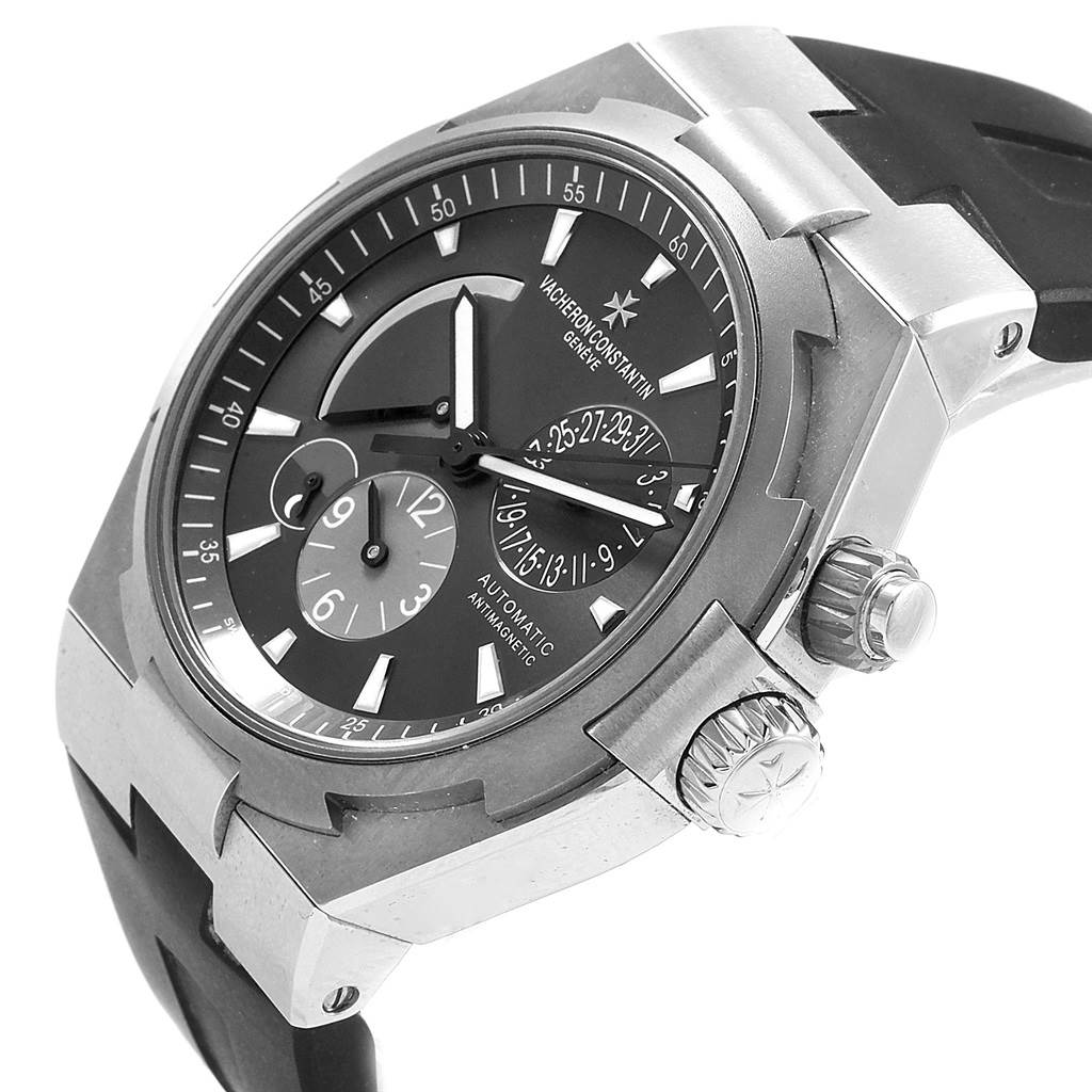 The Vacheron Constantin Overseas 47450/000W-9511 Men's Stainless Steel Grey Dial 47450/000W-9511 Men's Stainless Steel Grey Dial watch is shown at an angle, highlighting its dial, case, crown, and part of the strap.