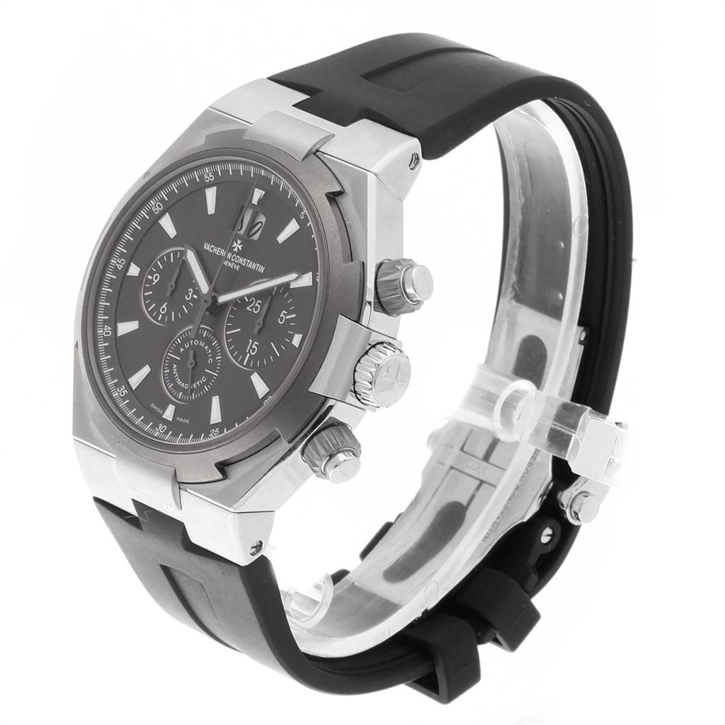 The image shows a side angle of a Vacheron Constantin Overseas VACHERON CONSTANTIN Men's Stainless Steel Grey Dial VACHERON CONSTANTIN Men's Stainless Steel Grey Dial watch, highlighting its dial, pushers, crown, and rubber strap.
