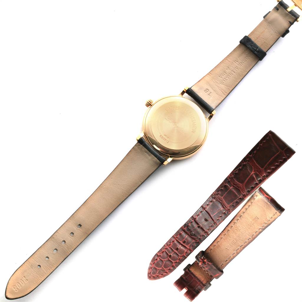 This image shows the back of a Vintage Vacheron Constantin watch with a beige leather strap, alongside a pair of maroon alligator leather watch bands.