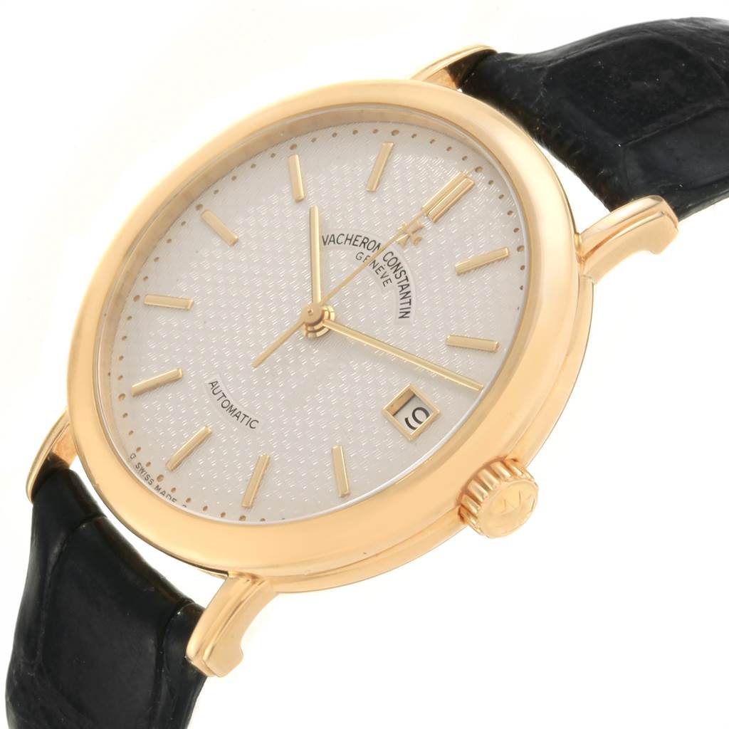 This image shows a Vacheron Constantin Vintage 47002 Men's Yellow Gold Silver Dial 47002 Men's Yellow Gold Silver Dial model watch at an angled view, highlighting the gold casing, crown, dial, and leather strap.