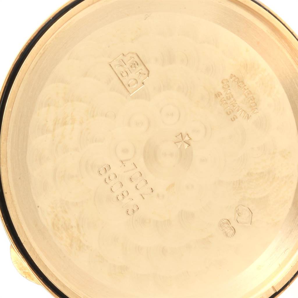 The image shows the inner case back of a Vintage Vacheron Constantin watch, highlighting the engravings and gold markings.